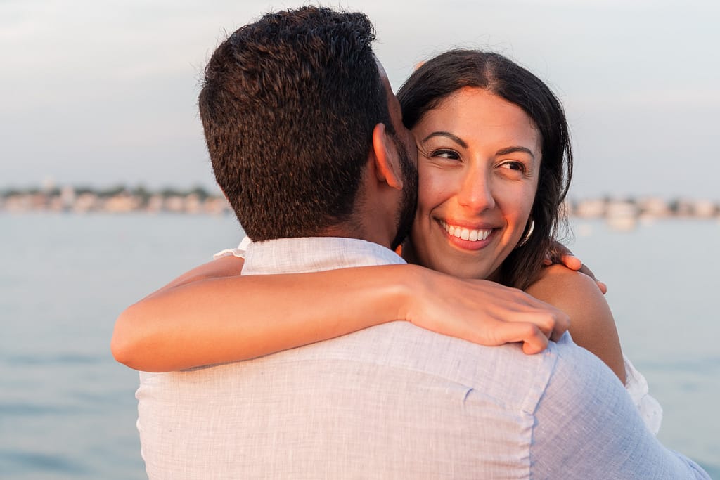 woman smiles after ocean house surprise proposal