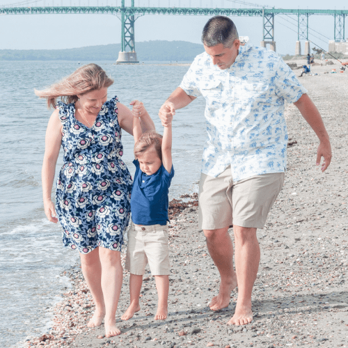 mom and dad lifting boy at the beach during portsmouth family photographysession