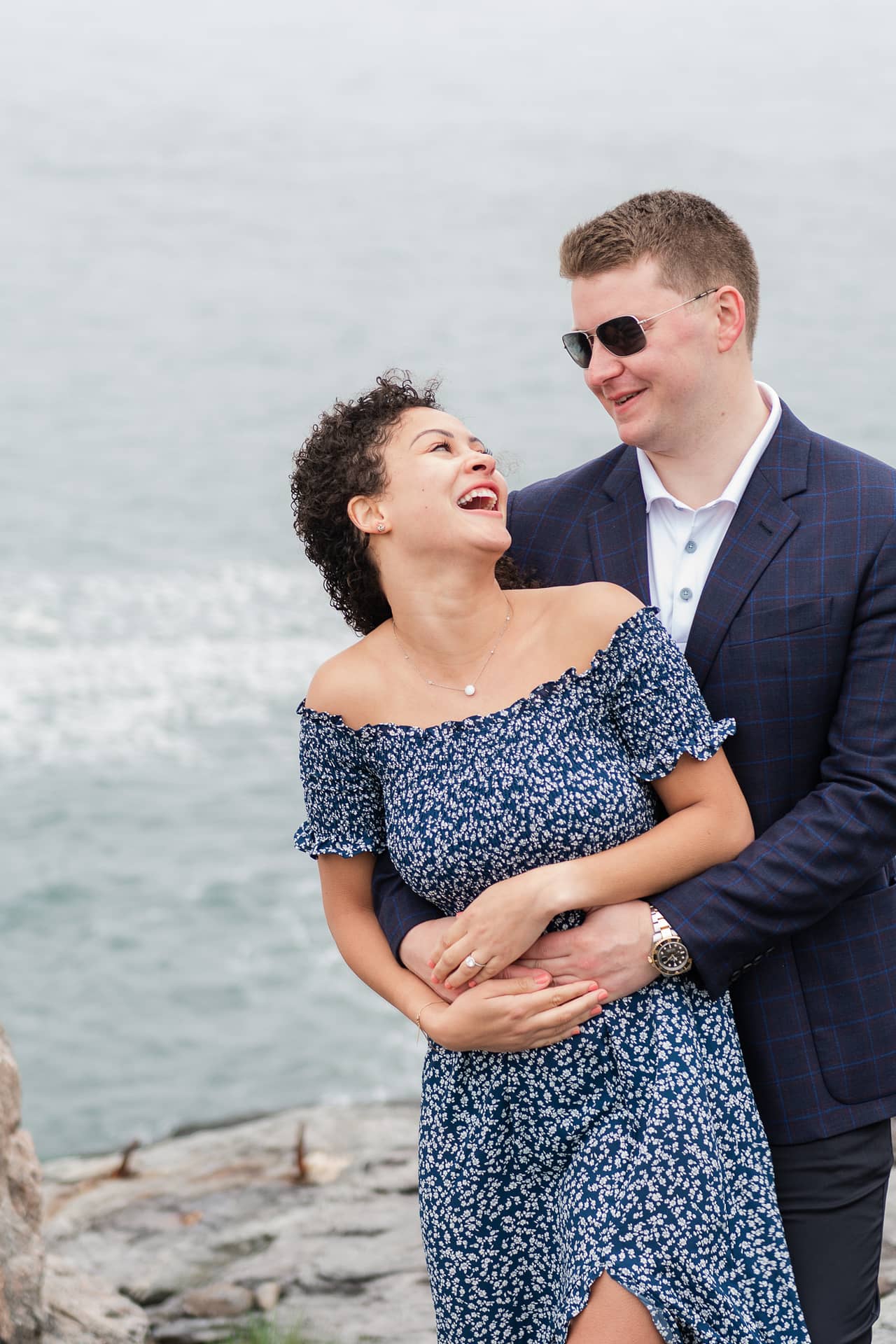 engaged couple laughs at castle hill inn in newport