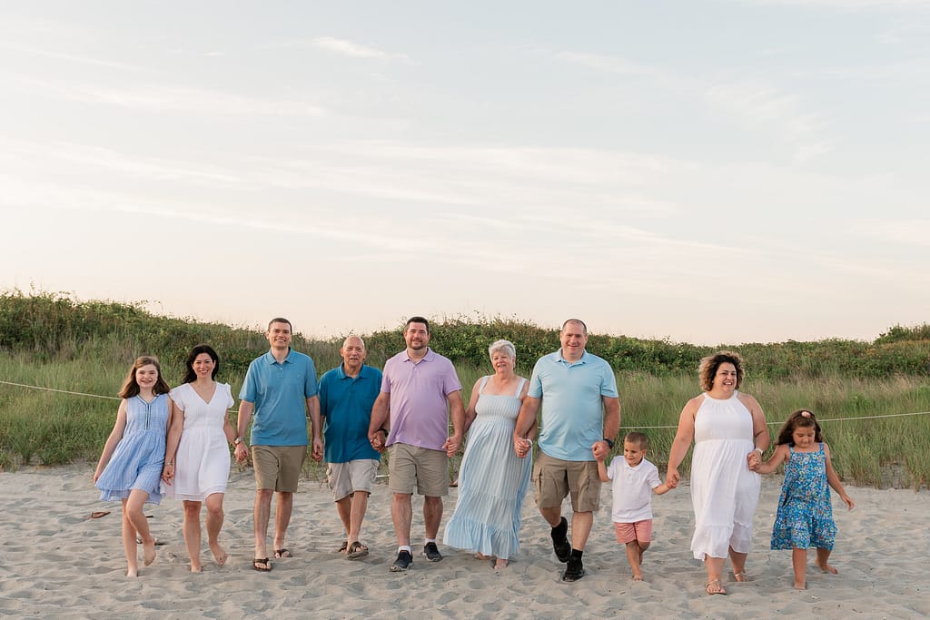 family walks for family portrait on beach