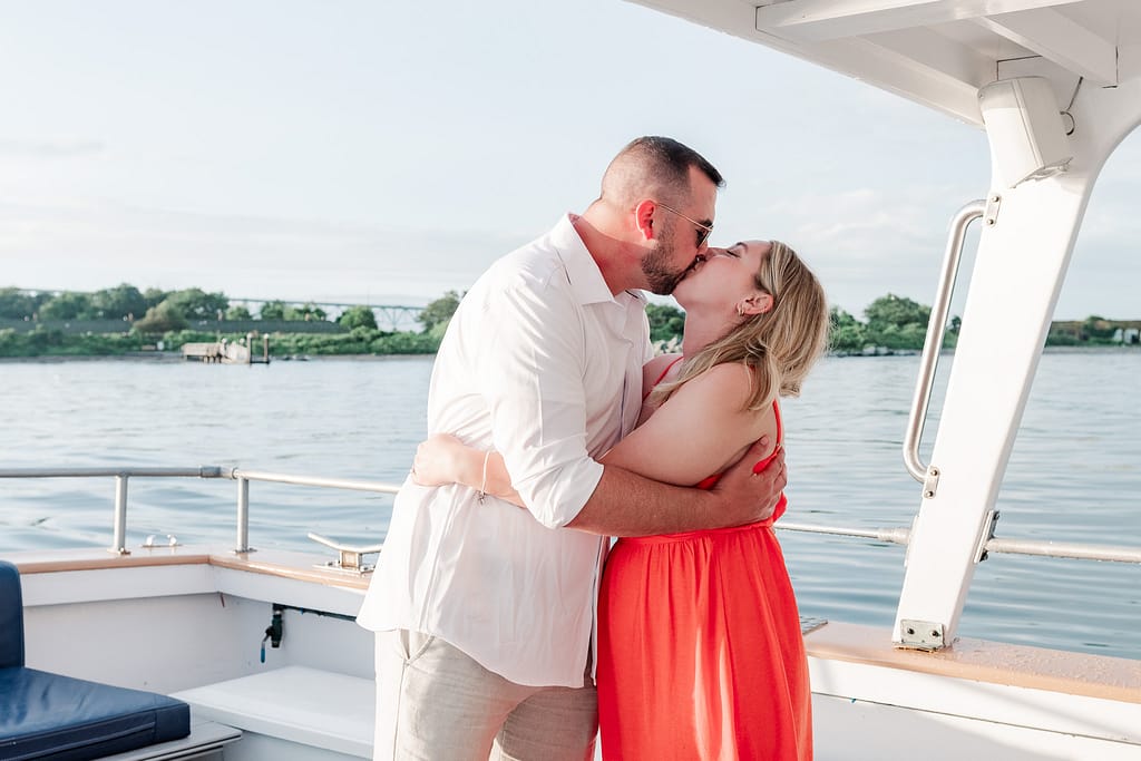 couple kisses on charter boat in newport