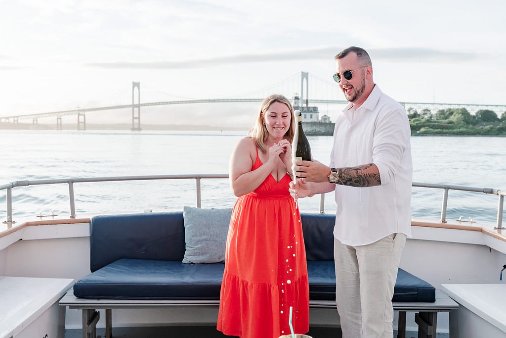 couple pops champagne after newport surprise proposal