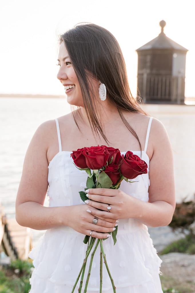 engaged woman smiles with roses