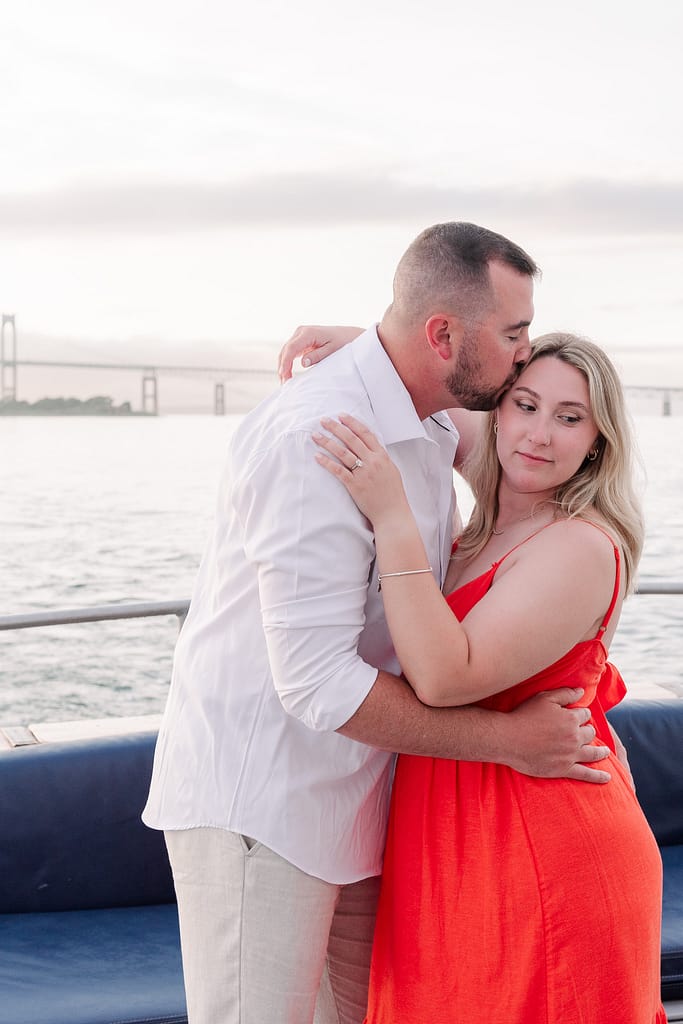 couple poses for engagement photos in newport