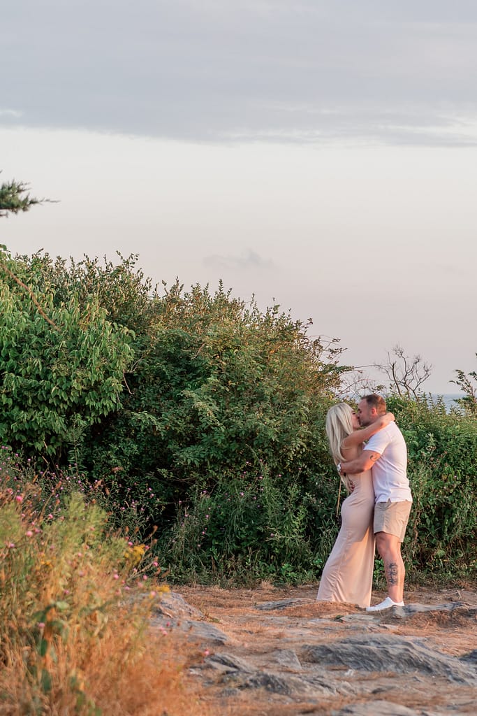 couple kisses after proposal at castle hill