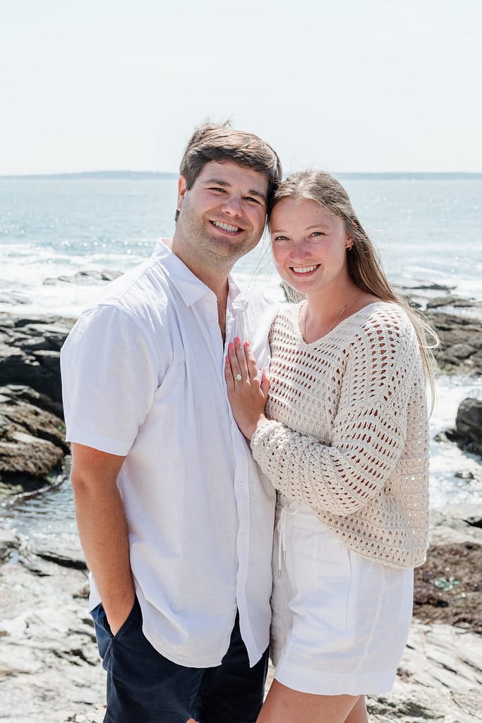 couple poses near beavertail lighthouse
