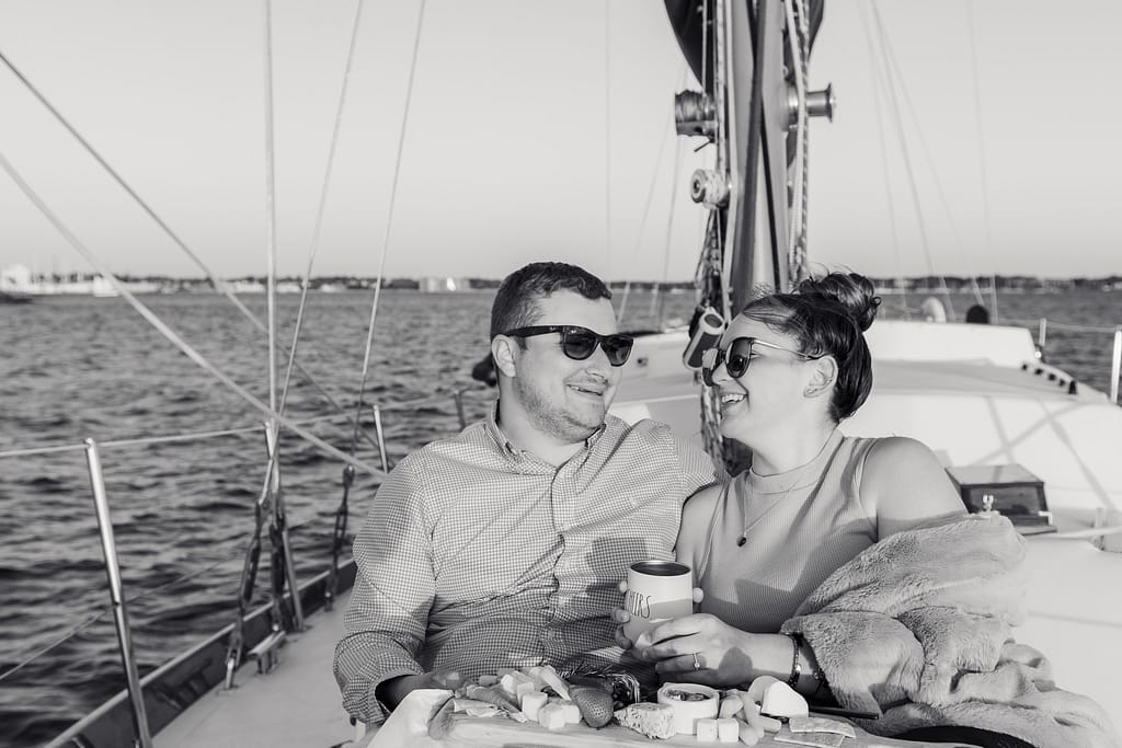 couple smiles on sunset cruise in newport rhode island
