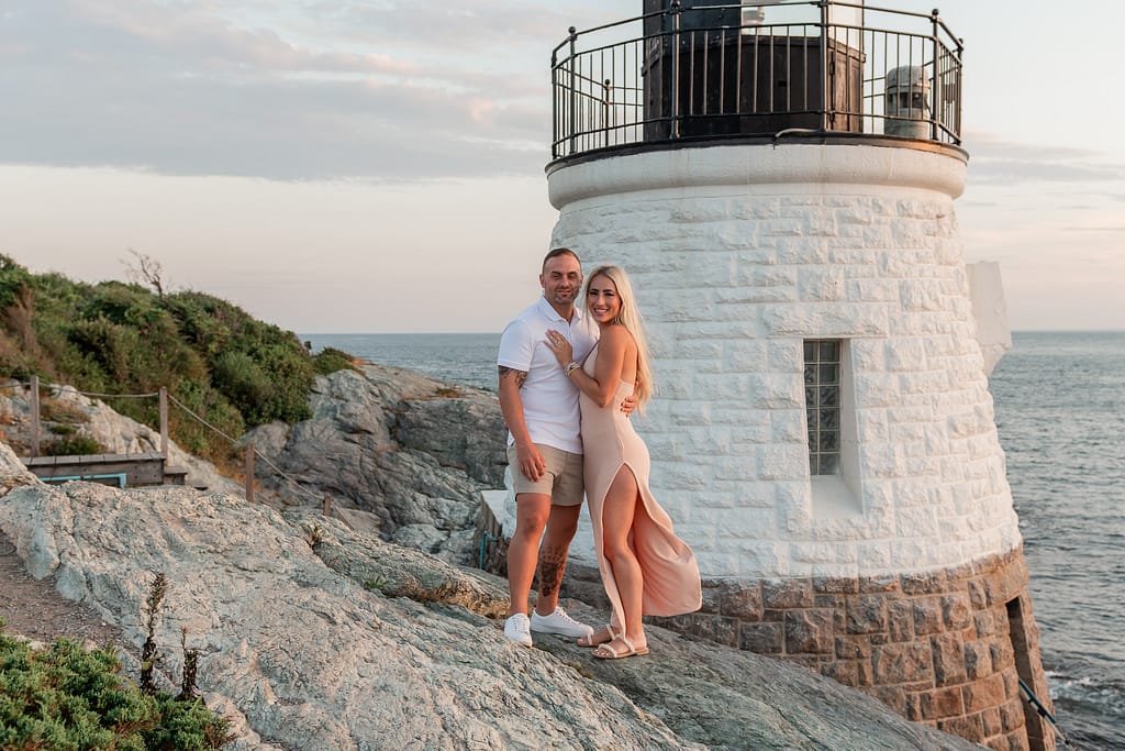 couple stands near castle hill lighthouse after proposal
