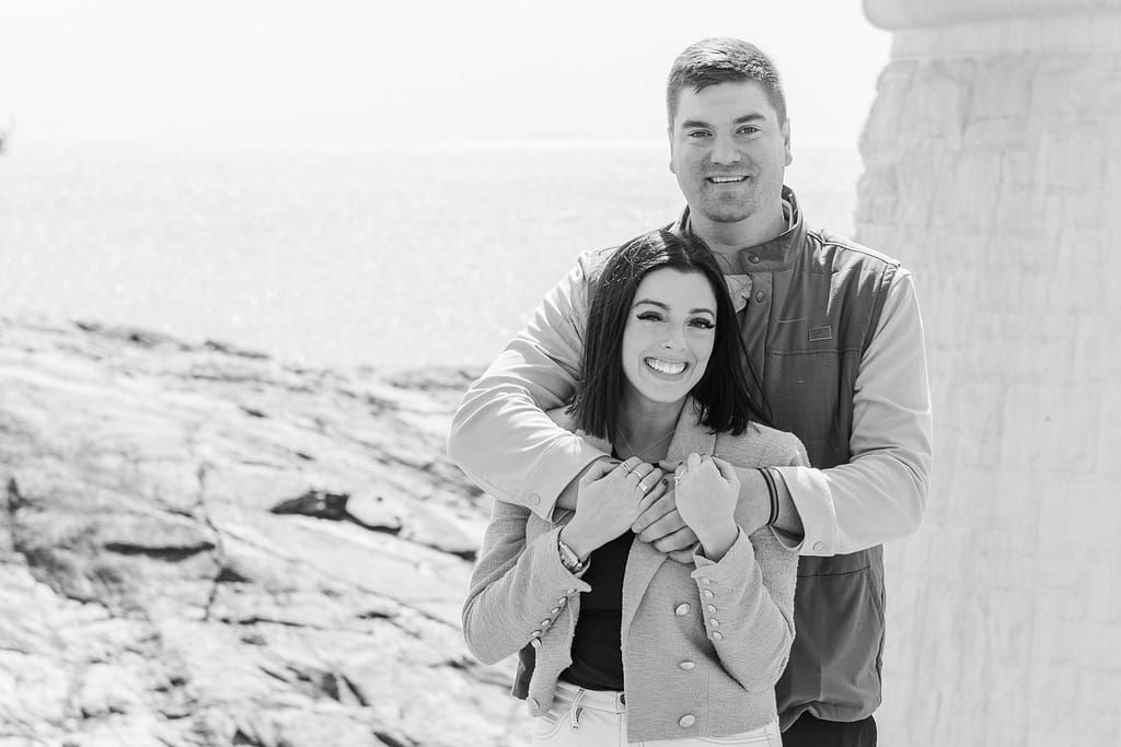 couple smiles after lighthouse proposal at castle hill