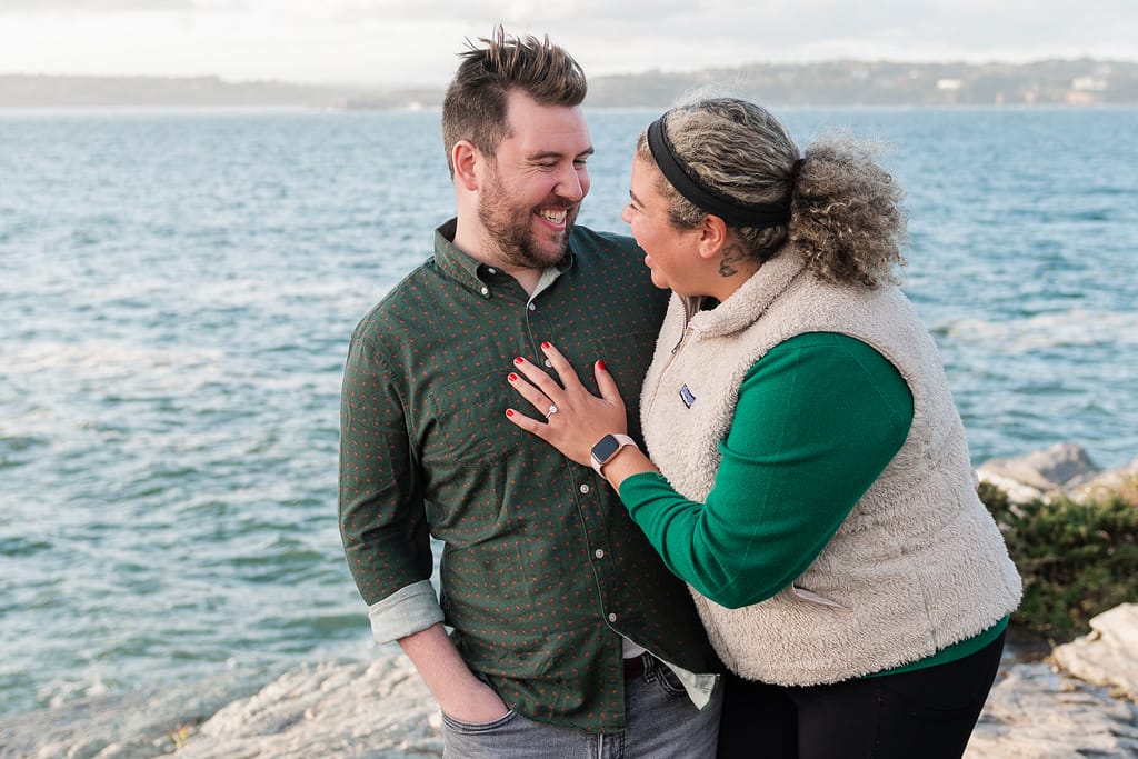 couple laughs after fall proposal in newport