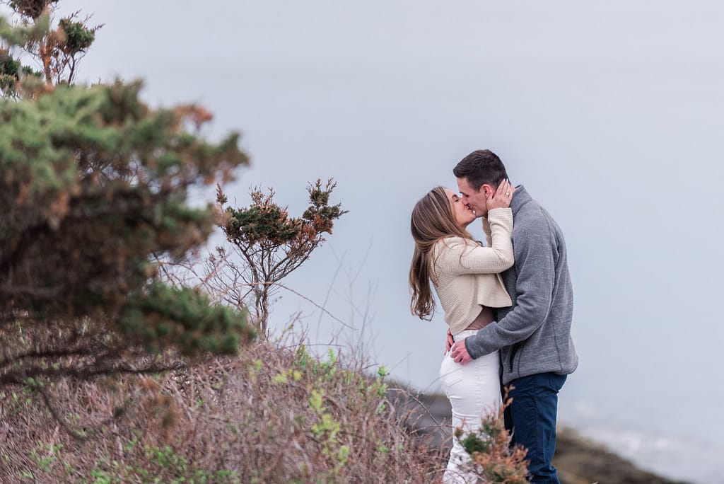 couple kisses after castle hill surprise engagement