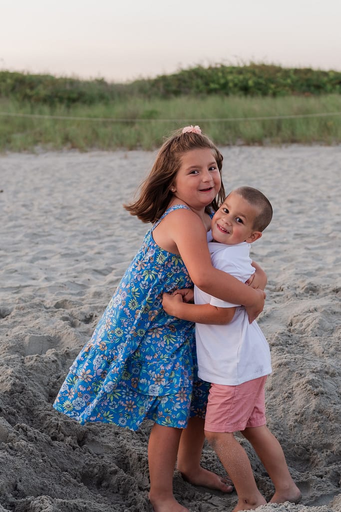 kids hug on beach