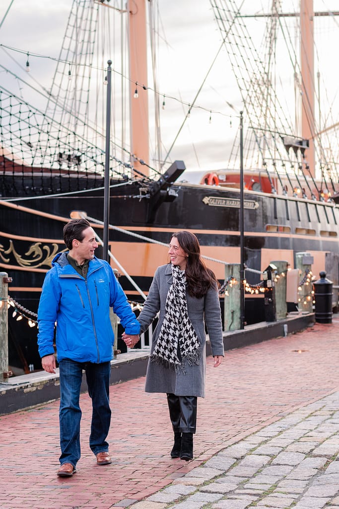 couple walks downtown after proposal at gurney's in newport