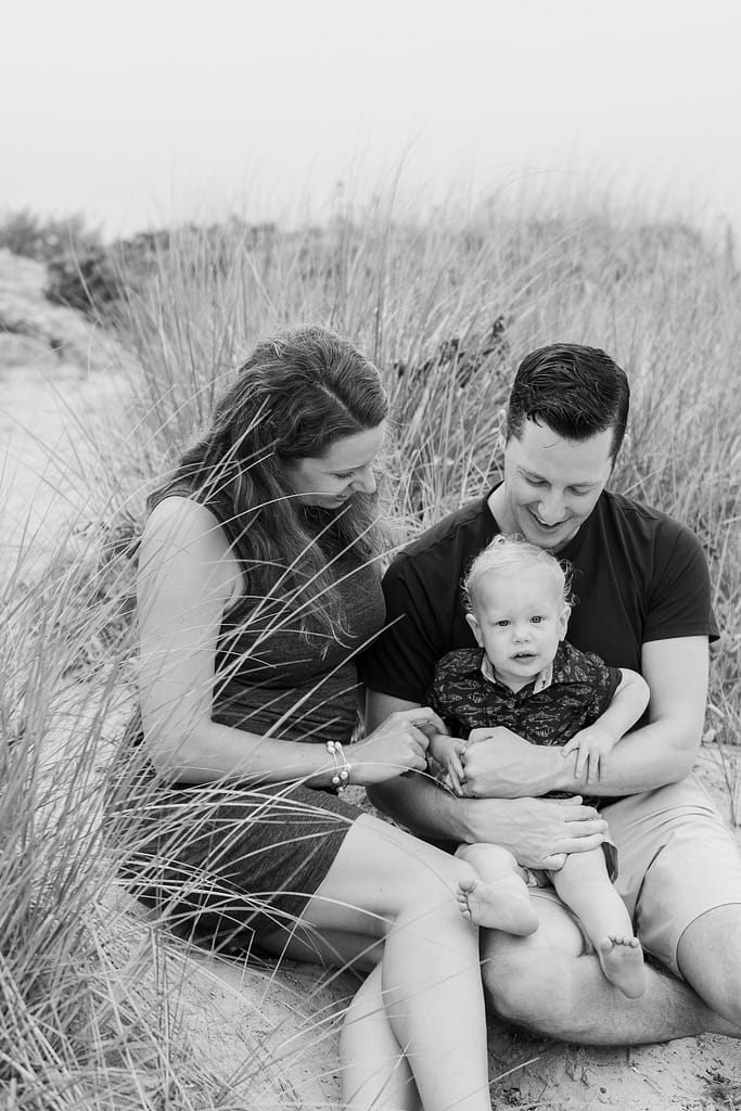 parents look at son in dune grass