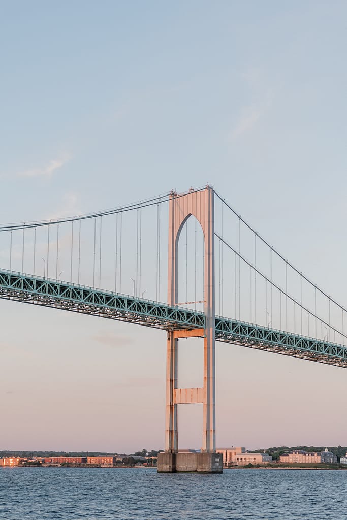 view of the newport bridge from a sunset cruise