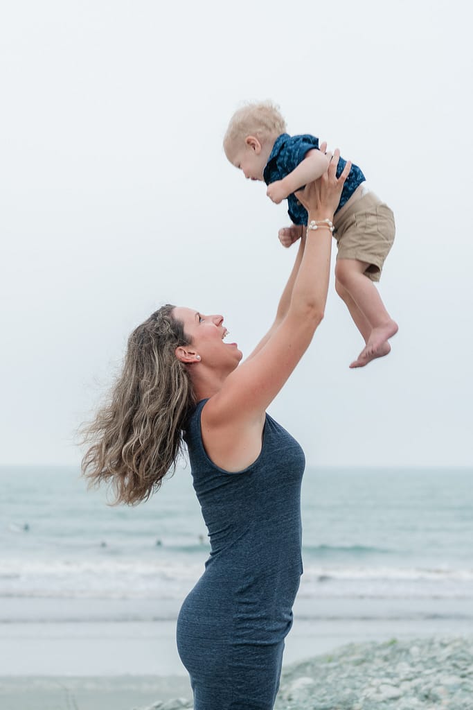 mom swings boy into air for middletown beach portraits