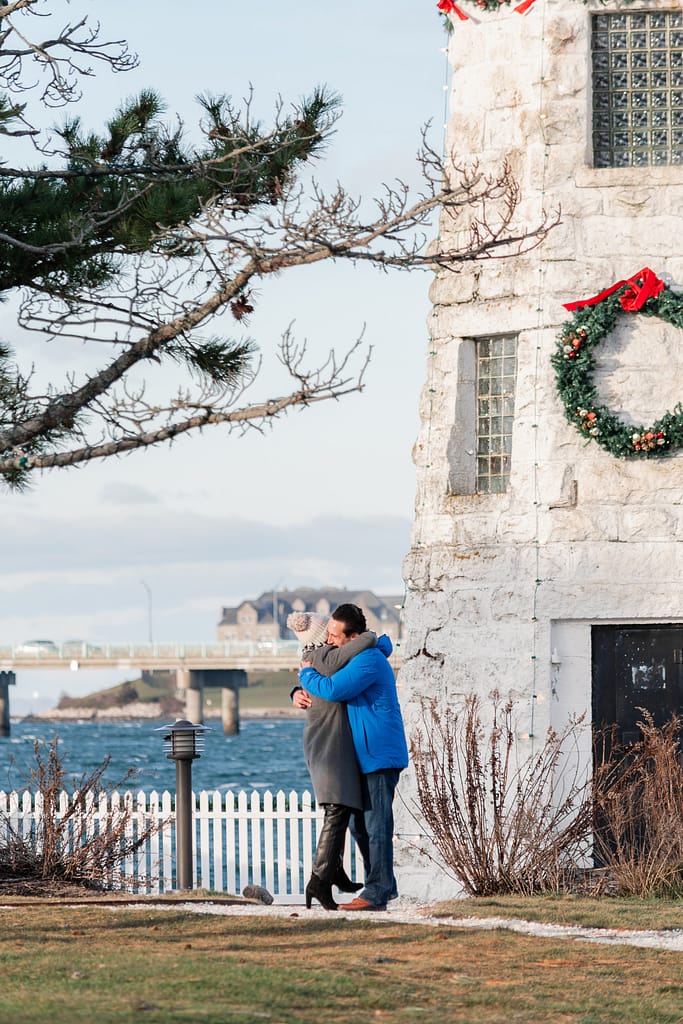 couple hugs after proposal at gurney's in newport