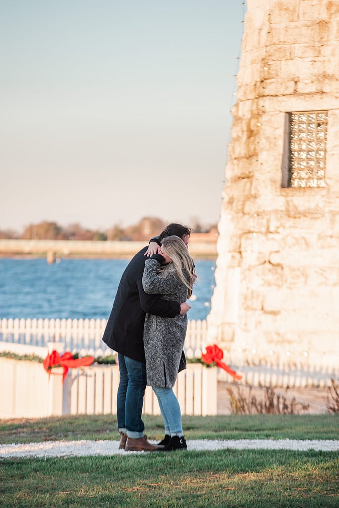 couple hugs after proposal at proposal at gurneys newport harbor island resort
