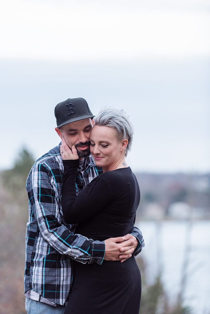 couple snuggles for engagement photos